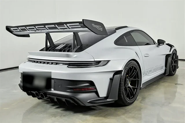 Rear three-quarter view showing the swan-neck wing mounts and rear diffuser