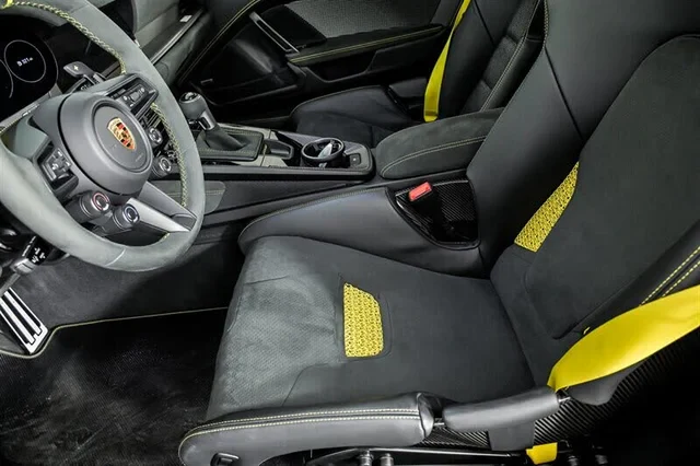 Race-Tex bucket seat detail with yellow perforated inserts and contrast stitching