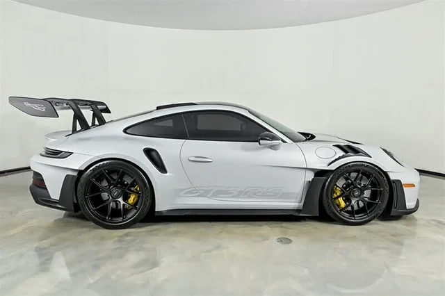 Ice Grey 911 GT3 RS in side profile, swan-neck rear wing raised above the roofline